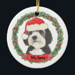 Personalized Bernedoodle Santa Hat Christmas Ceramic Ornament<br><div class="desc">I am in love with this beautifully detailed watercolor illustration of a grey, black, and white bernedoodle or sheepadoodle on an ornament in a sweet santa hat! Personalize these and make the nice list this year! For the perfect presents, pair it with a matching item from the collection for a...</div>