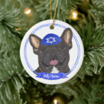 Personalized Black Brindle Frenchie Hanukkah Ceramic Ornament<br><div class="desc">Celebrate your favorite mensch on a bench with a personalized ornament! This design features a sweet illustration of a black or brindle french bulldog dog with a blue and white yarmulke. For the most thoughtful gifts, pair it with another item from my collection! To see more work and learn about...</div>