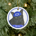 Personalized Black Cat Hanukkah Yarmulke Blue Ceramic Ornament<br><div class="desc">Celebrate your favorite mensch on a bench with personalized ornament! This design features a sweet illustration of a black cat with a blue and white yarmulke. For the most thoughtful gifts, pair it with another item from my collection! To see more work and learn about this artist, visit her at...</div>