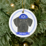 Personalized Black Great Dane Dog Hanukkah Ceramic Ornament<br><div class="desc">Celebrate your favorite mensch on a bench with personalized ornament! This design features a sweet illustration of a black great dane dog with a blue and white yarmulke. For the most thoughtful gifts, pair it with another item from my collection! To see more work and learn about this artist, visit...</div>