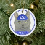 Personalized Chartreux Cat Yarmulke Blue White Ceramic Ornament<br><div class="desc">Celebrate your favorite mensch on a bench with personalized ornament! This design features a sweet illustration of a grey chartreux cat with a blue and white yarmulke. For the most thoughtful gifts, pair it with another item from my collection! To see more work and learn about this artist, visit her...</div>