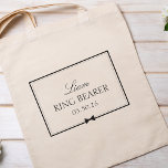 Personalized Classic Simple Bowtie Ring Bearer Tote Bag<br><div class="desc">Celebrate your ring bearer in style with this charming, customizable tote bag. Featuring an elegant black-and-white design, it showcases the ring bearer's name, title, and special date framed by a sleek border and a delicate bowtie illustration. Perfect for holding wedding day essentials, this tote adds a thoughtful touch to your...</div>