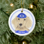 Personalized English Cream Dachshund Dog Hanukkah Ceramic Ornament<br><div class="desc">Celebrate your favorite mensch on a bench with personalized ornament! This design features a sweet illustration of a fawn, tan, or cream english long haired dachshund dog with a blue and white yarmulke. For the most thoughtful gifts, pair it with another item from my collection! To see more work and...</div>