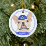 Personalized Fawn Tan Frenchie Dog Hanukkah Ceramic Ornament<br><div class="desc">Celebrate your favorite mensch on a bench with a personalized ornament! This design features a sweet illustration of an entlebucher mountain dog with a blue and white yarmulke. For the most thoughtful gifts, pair it with another item from my collection! To see more work and learn about this artist, visit...</div>