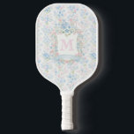 Personalized Floral Monogram Pickleball Paddle<br><div class="desc">Play with timeless grace using this personalized floral monogram pickleball paddle. Featuring a soft all-over pattern of pastel blossoms in gentle blues, blush pinks, and airy greenery, this design brings classic, heirloom-inspired beauty to the court. The centered monogram is framed by an elegant floral wreath and ribbon detail, creating a...</div>