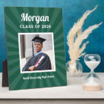 Personalized Green Class of 2025 Graduation Photo Plaque<br><div class="desc">Modern and minimal plaque display sign with easel for the graduation party will showcase your graduate! Design features a square photo of the grad framed in white with simple and classic first name, class year, and school name wording that can be personalized. Includes a subtle starburst pattern. Dark green background...</div>