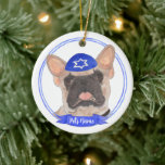 Personalized Masked Frenchie Hanukkah Ceramic Ornament<br><div class="desc">Celebrate your favorite mensch on a bench with a personalized ornament! This design features a sweet illustration of a fawn masked frenchie or french bulldog with a blue and white yarmulke. For the most thoughtful gifts, pair it with another item from my collection! To see more work and learn about...</div>