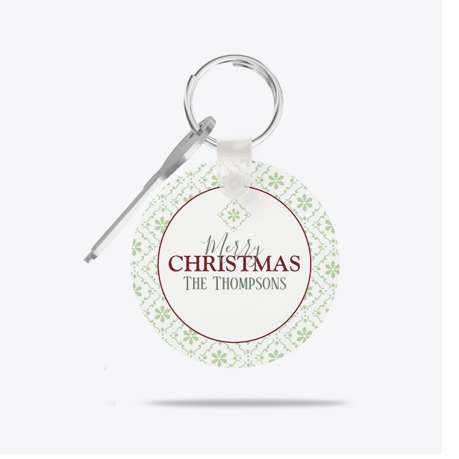 Personalized Merry Christmas Family Name Keychain (Festive Merry Christmas personalized keychain with green snowflakes and custom family name.)