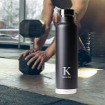 Personalized name monogram black and white water bottle<br><div class="desc">Modern trendy simple minimal black and white masculine stylish water bottle with minimalist typography.            Personalized keepsake gift for him: dad,  father,  husband,  son,  groomsman,  best man,  or friend on birthday,  anniversary,  Christmas,  wedding or any other occasion.</div>