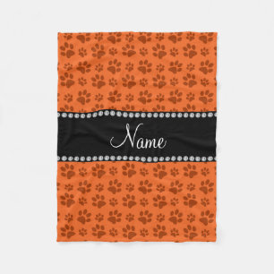Personalized name orange dog paw print fleece blanket