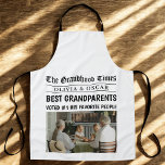 Personalized Newspaper Headline | Best Grandparent Apron<br><div class="desc">Make their time in the kitchen even more special with this fun and heartwarming "Grandhood Times" personalized apron! Styled like a newspaper front page, this custom apron features your favorite family photo, the grandkids’ names, and a bold headline declaring them the Best Grandparents Ever. A unique and practical gift for...</div>