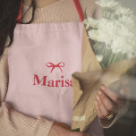 Personalized Pink & Red Bow Name Apron | Custom E<br><div class="desc">Cook in style with this personalized pink and red bow name apron, designed for elegance and functionality. Featuring a chic bow design in soft pink and bold red, this custom apron is the perfect blend of fashion and practicality. Personalize it with your name or initials to make it uniquely yours...</div>