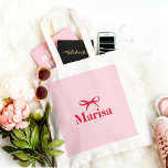Personalized Pink & Red Bow Name Tote Bag<br><div class="desc">Carry your essentials in style with this personalized pink and red bow name tote bag. Featuring a chic bow design in soft pink and bold red, this custom tote bag can be personalized with your name or initials for a one-of-a-kind accessory. Made from durable, high-quality canvas, this tote is perfect...</div>