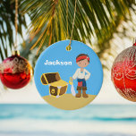 Personalized Pirate Kids Blue Boys Name Christmas Ceramic Ornament<br><div class="desc">Cute pirate kid wearing a red bandana carrying a sword next to a treasure chest filled with gold on a beach with blue sky background. Customize this unique little boy's Christmas ornament with your child's name in white. Ahoy,  matey!</div>