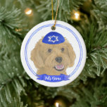 Personalized Red Apricot Gold Doodle Dog Hanukkah Ceramic Ornament<br><div class="desc">Celebrate your favorite mensch on a bench with personalized ornament! This design features a sweet illustration of a red, apricot, or golden doodle dog with a blue and white yarmulke. For the most thoughtful gifts, pair it with another item from my collection! To see more work and learn about this...</div>