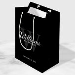 Personalized Script Groomsmen's name and Monogram  Medium Gift Bag<br><div class="desc">Add a personal touch to your wedding with personalized groomsmen gift bag. This gift bag features personalized groomsman's name in white classic script font style with wedding details in white classic serif font style and monogram in grey classic serif font style as background, on black background. Also perfect for best...</div>