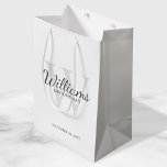 Personalized Script Groomsmen's name and Monogram Medium Gift Bag<br><div class="desc">Add a personal touch to your wedding with personalized groomsmen gift bag. This gift bag features personalized groomsman's name in grey classic script font style with wedding details in grey classic serif font style and monogram in light grey classic serif font style as background, on white background. Also perfect for...</div>