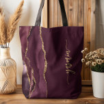 Personalized Signature Burgundy Gold Agate Tote Bag<br><div class="desc">Personalize this elegant modern design with your name in vertical gold-colored signature handwriting script on a burgundy background with a border of burgundy watercolor agate trimmed with gold faux glitter. (To keep the swashes at the beginning and end of the name, replace only the letters, leaving the symbols in place.)...</div>