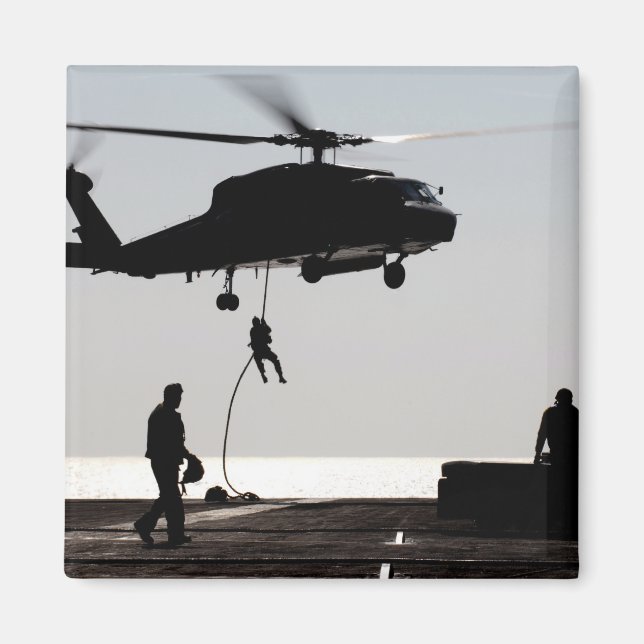 Personnel fast-rope out of an SH-60F Magnet (Front)