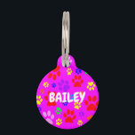 Pet Paws on Pink Round Pet ID Tag<br><div class="desc">Image of random coloured pet paws on a pink background.</div>