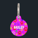 Pet Paws on Pink Round Pet ID Tag<br><div class="desc">Image of random coloured pet paws on a pink background.</div>