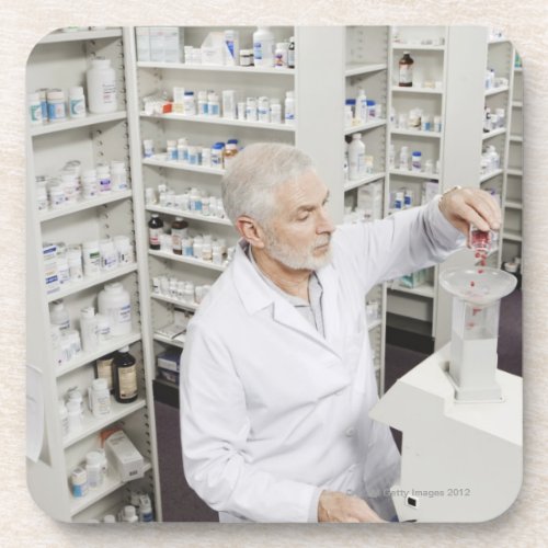 Pharmacist pouring pills into counting machine beverage coaster