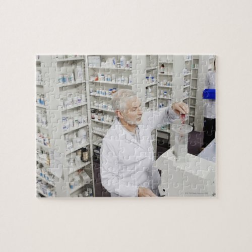 Pharmacist pouring pills into counting machine jigsaw puzzle
