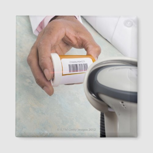 Pharmacist scanning pill bottle with a barcode magnet