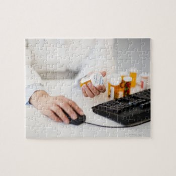Pharmacist With Pill Bottles At Computer Jigsaw Puzzle by prophoto at Zazzle
