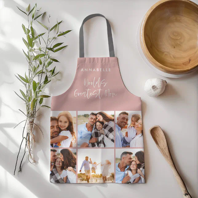A pink apron with 6 personalized photos. In the background, there's a wooden spoon, bowl, clove of garlic, and some sprigs.