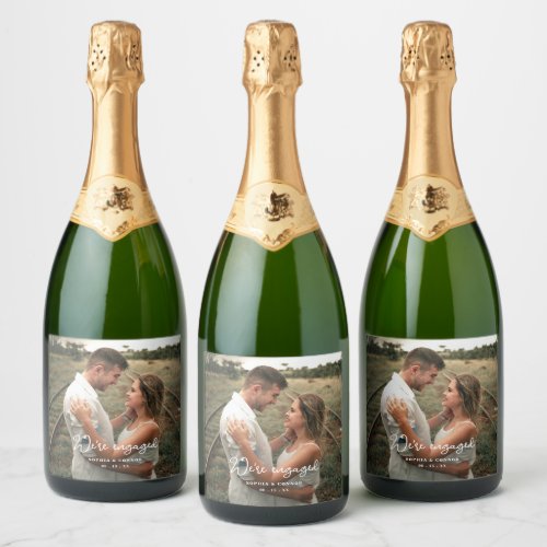 Photo Modern Script Were Engaged Engagement Party Sparkling Wine Label