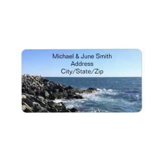 Photo of Beautiful Ocean Waves Against Rocky Shore Label