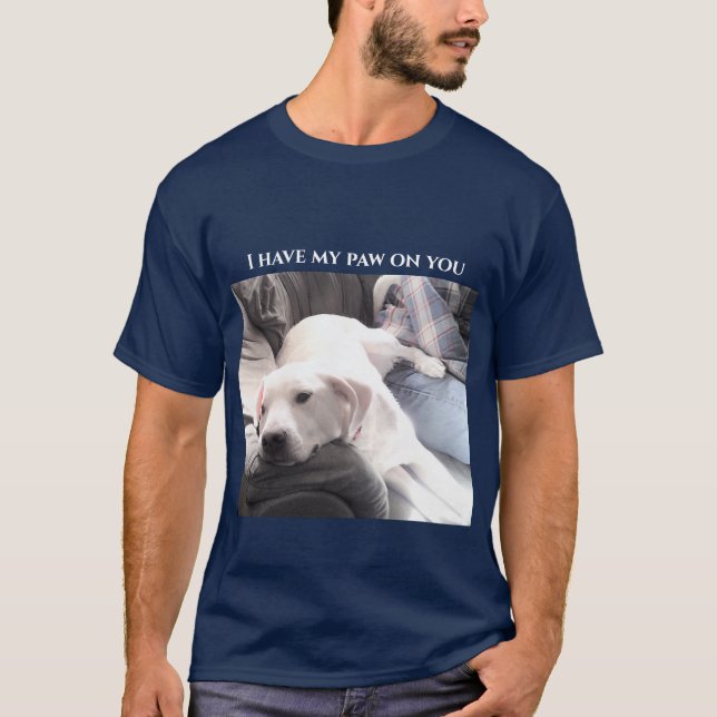 Photo of Cute White Dog With Back Paw On Dad Blue T-Shirt (Front)