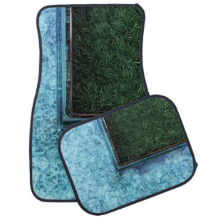 Photo of green grasses near tiles car floor mat