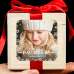 Photo Peace Love Joy Elegant Gold Snowflake Custom Square Sticker<br><div class="desc">“Peace, love & joy.” A playful visual of champagne gold glitter snowflakes, white handwritten typography and confetti dots against the photo of your choice, helps you usher in Christmas and New Year. Feel the warmth and joy of the holiday season whenever you use this stylish and modern custom sticker. Matching...</div>