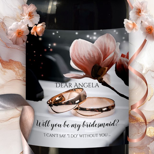 Piano Music Wedding Rings Bridesmaid Wine Label (Romantic wedding wine label featuring rose gold wedding bands on a piano, with a magnolia flower)