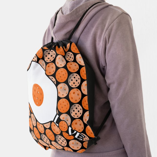 Pickleball Paddle Love Orange Pickleballs on Black Drawstring Bag (Insitu)