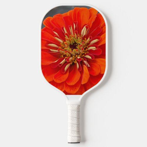 pickleball paddle with a orange flower