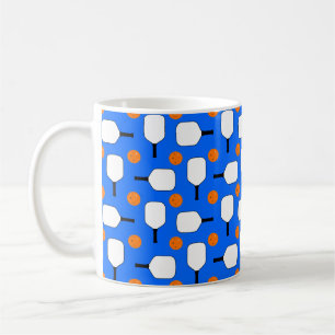 Pickleball Paddles, Orange Pickleball Balls, Blue Coffee Mug