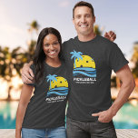 Pickleball Tropical Palm Tree Sun Your Custom Text T-Shirt<br><div class="desc">A fun pickleball tshirt featuring a pickleball "sun" framed by a tropical palm tree and blue ocean waves. Add your custom text below - club name, pickleball weekend date/location, tournament name, player names, etc. Makes a perfect gift for any pickleball player - Wear as matching t-shirts for tournament play, perfect...</div>