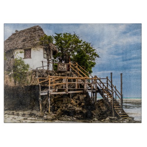 Picturesque house on a tropical coral outcrop cutting board