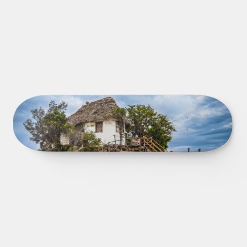 Picturesque house on a tropical coral outcrop skateboard