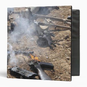 Pieces of enemy weapons lay out to cool off binder