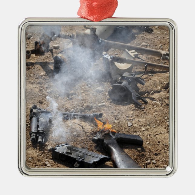 Pieces of enemy weapons lay out to cool off metal ornament (Front)