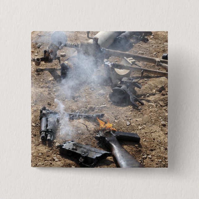 Pieces of enemy weapons lay out to cool off pinback button (Front)