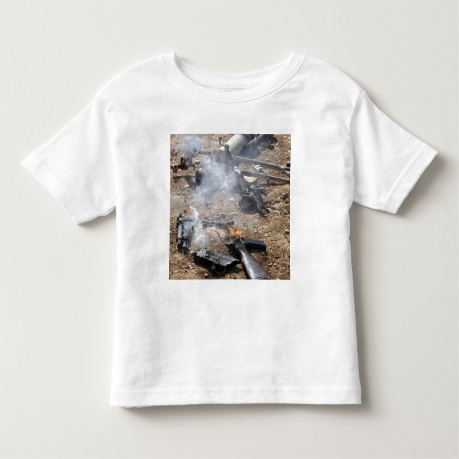 Pieces of enemy weapons lay out to cool off toddler t-shirt (Front)