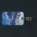 Pike Market Seattle Luggage Tag<br><div class="desc">The image captures a rainy evening scene at Pike Place Market in Seattle, Washington. The iconic 'Public Market Center' sign glows with red neon lights, reflected in the wet surface of a car hood. Other vehicles are parked nearby, and the surrounding buildings are visible in the background. The overall mood...</div>