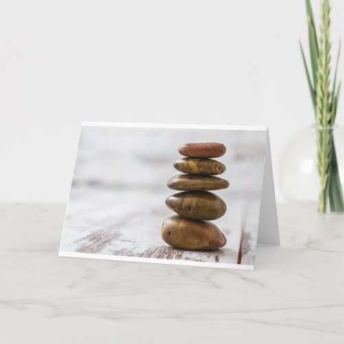 Pile of dark colored stones on white background card