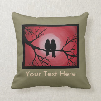 Pillow of love birds on a tree branch.