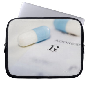 Pills on written prescription laptop sleeve
